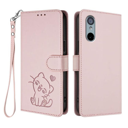 Light pink leather-style phone case with embossed cat and heart pattern and wrist strap