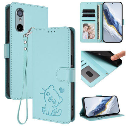 Light blue leather-style phone case with embossed cat-and-heart design and wrist strap
