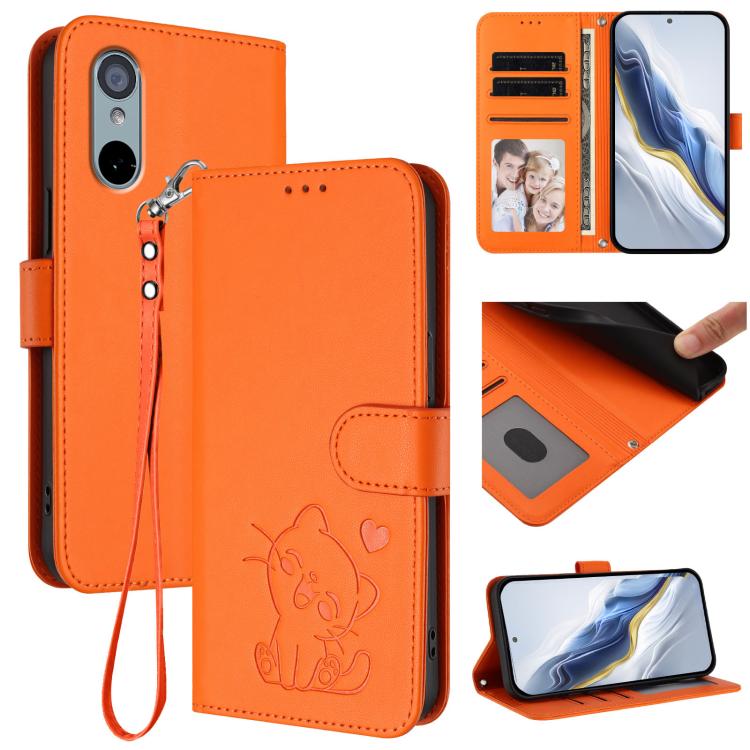 Orange leather phone case with embossed cat and heart, hand strap, folio wallet design.