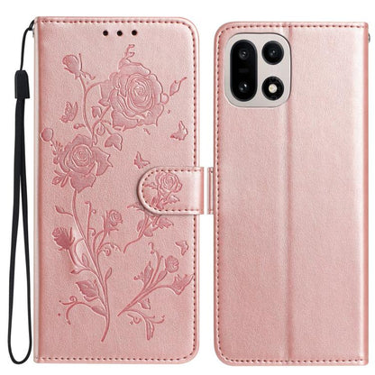 Pink faux leather phone wallet case with embossed floral rose pattern and wrist strap.