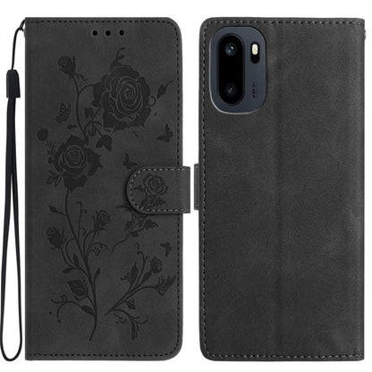Black faux leather phone wallet case with embossed floral rose pattern and wrist strap.