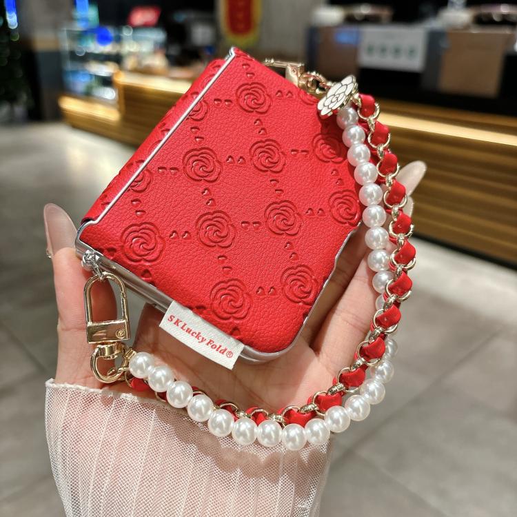 Red embossed rose phone case with side buckle and pearl-and-chain bracelet strap