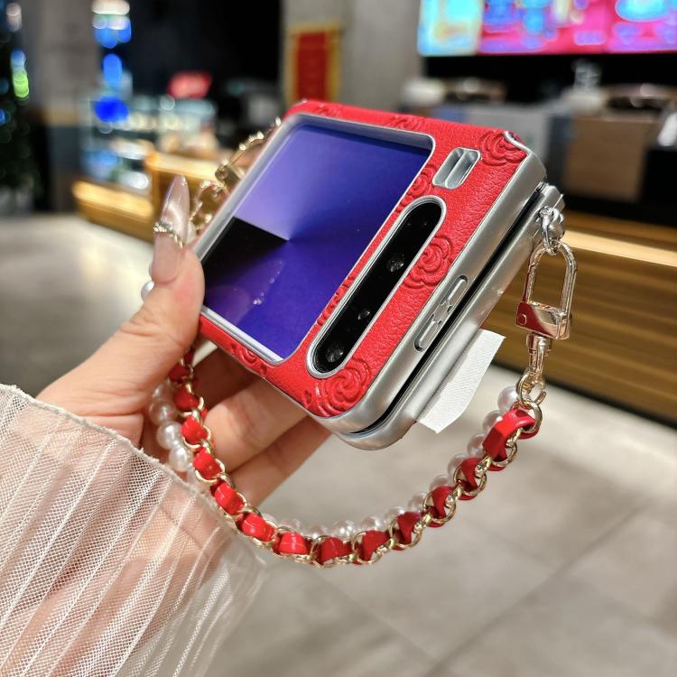 Red and silver phone case with embossed rose pattern and red pearl bracelet strap
