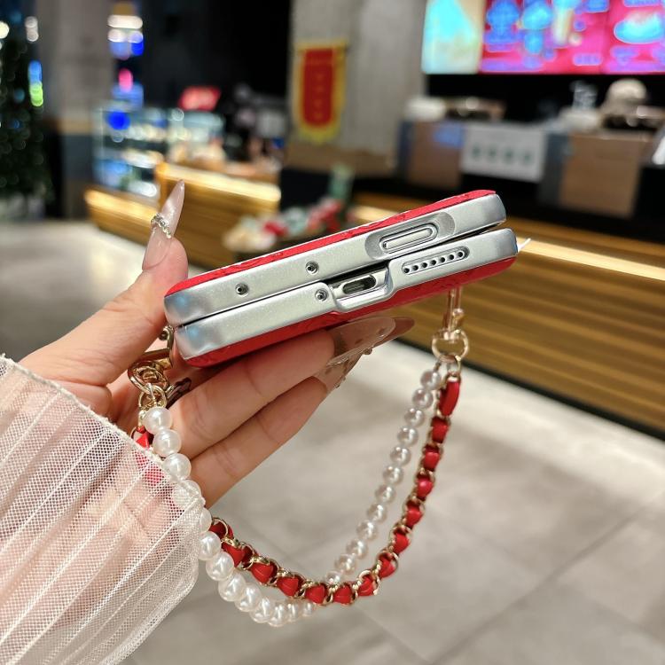 Red and silver phone case with side buckle and pearl-and-chain bracelet strap