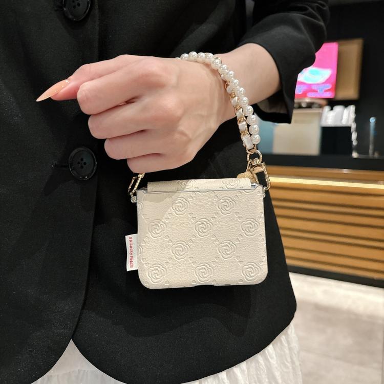 Beige embossed rose phone case with side buckle and pearl bracelet strap