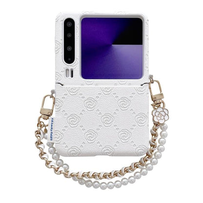 White embossed phone case with rose pattern, side buckle, and pearl bead wrist strap