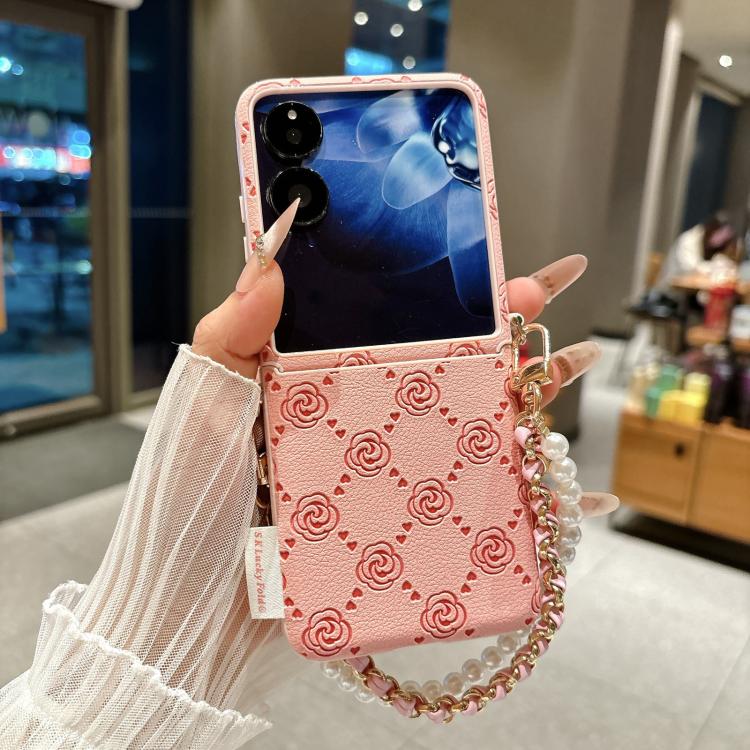 Pink embossed rose phone case with side buckle, pearl and chain wrist strap