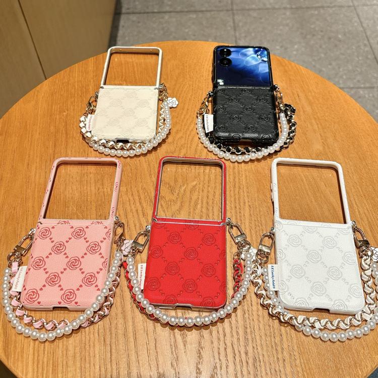 Assorted rose-embossed phone cases with pearl-bead chain straps on display