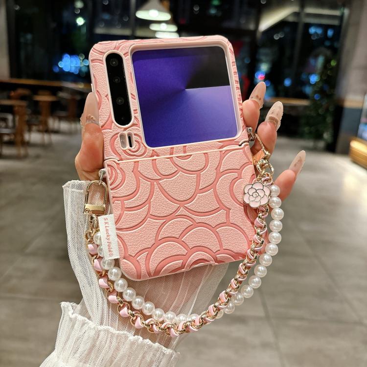Pink embossed phone case with camellia detail, side buckle, and pearl chain strap