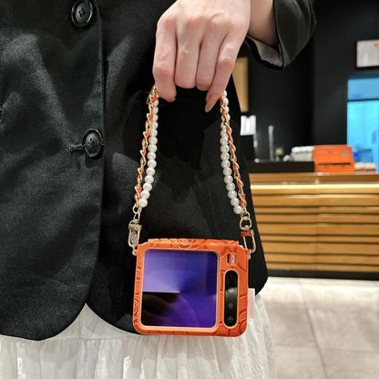 Orange embossed camellia phone case with side buckle and pearl chain lanyard strap