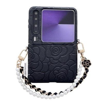 Black embossed camellia phone case with side buckle and pearl chain shoulder strap