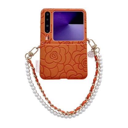 Orange embossed camellia phone case with side buckle and pearl-bead bracelet chain