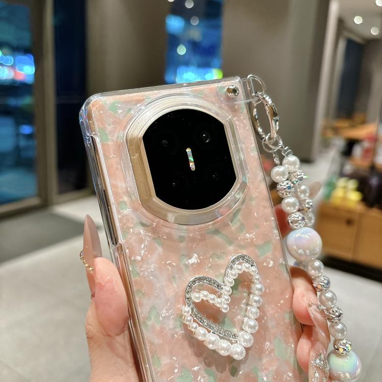 Iridescent shell phone case with pearl heart applique and beaded love bracelet