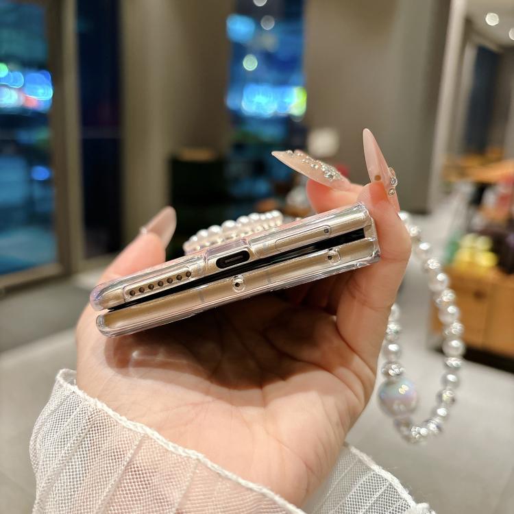 Phone case bottom view with beaded love bracelet and pearl heart detail