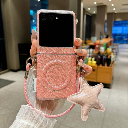 Pink magnetic phone case with litchi texture, wrist strap, and star charm