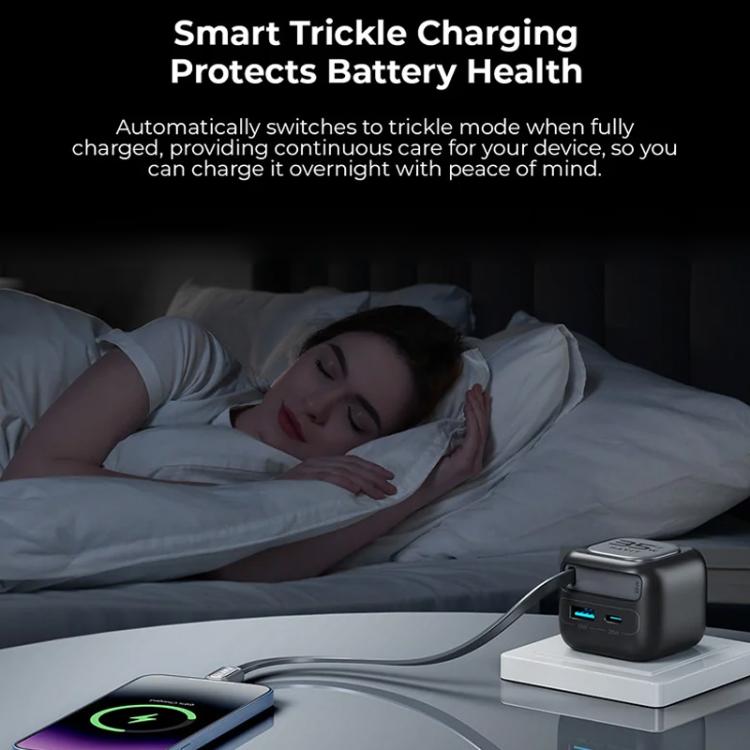 GaN travel charger with connected cable and glowing status indicator on a tabletop