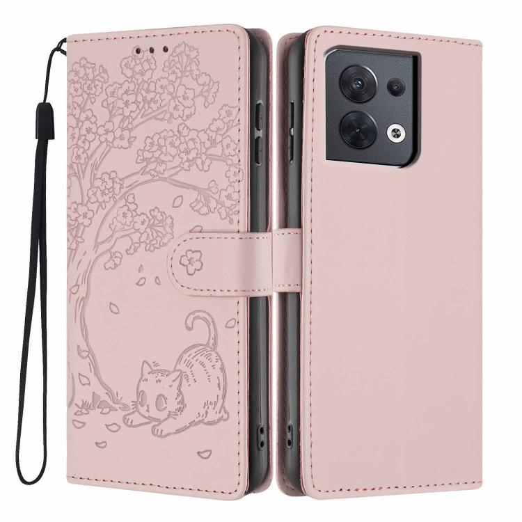 Blush pink tree-cat embossed flip vegan leather phone case with wrist strap.