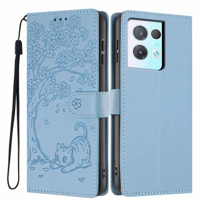 Light sky blue tree-cat embossed flip vegan leather phone case with wrist strap.