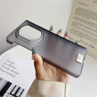 Dark gray matte phone case with oval camera cutout and nameplate on back