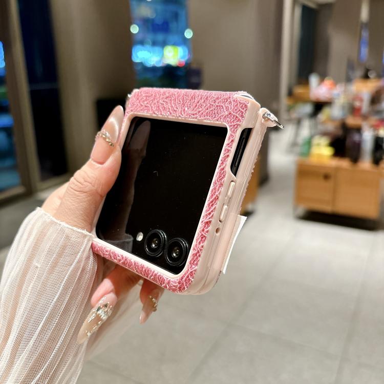 Pink lace-embossed phone case with beaded wrist strap and side cutouts