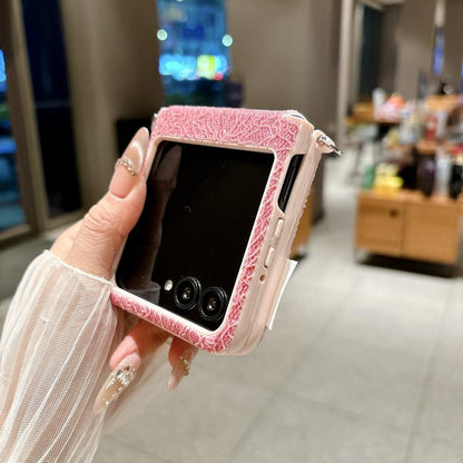 Pink lace-embossed phone case with beaded wrist strap and side cutouts