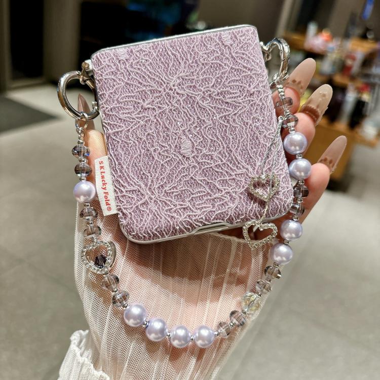 Lavender lace-embossed phone case with beaded wrist strap and heart charms