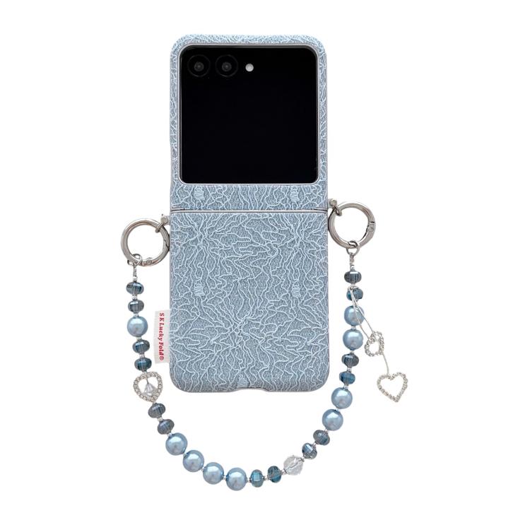 Light blue lace-embossed phone case with dual metal hooks and beaded wrist strap