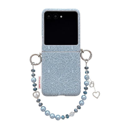 Light blue lace-embossed phone case with dual metal hooks and beaded wrist strap