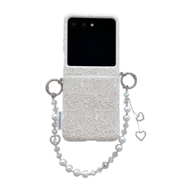 White lace-embossed phone case with metal hooks and pearl beaded wrist strap