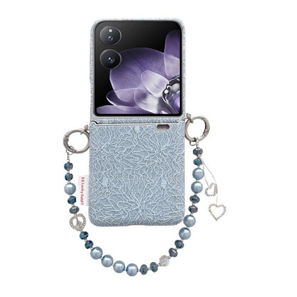 Light blue lace-embossed phone case with metal hooks and pearl wrist strap