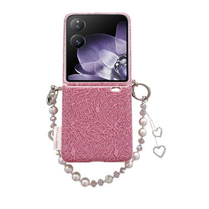 Pink lace-embossed phone case with metal hooks and pearl wrist strap