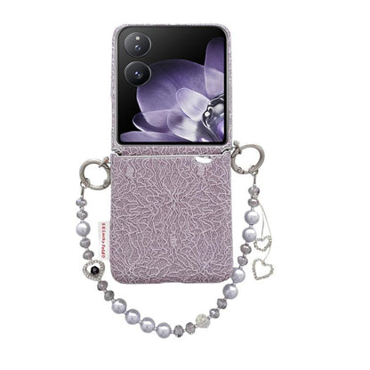 Purple lace-embossed phone case with metal hooks and beaded wrist strap with heart charms