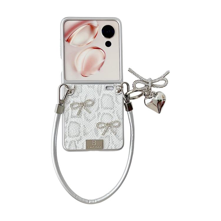 Silver scale-texture bow phone case with wrist strap and charm; front camera window