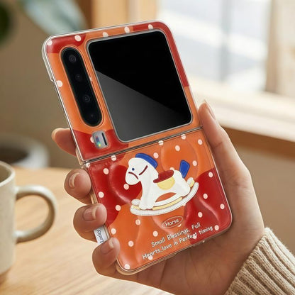 Orange phone case in hand, clear window with horse rocking on white polka dots