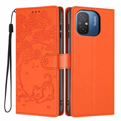 Tree-cat embossed vegan leather flip phone case with wrist strap, orange.