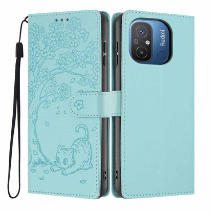 Tree-cat embossed vegan leather flip phone case with wrist strap, aqua blue.