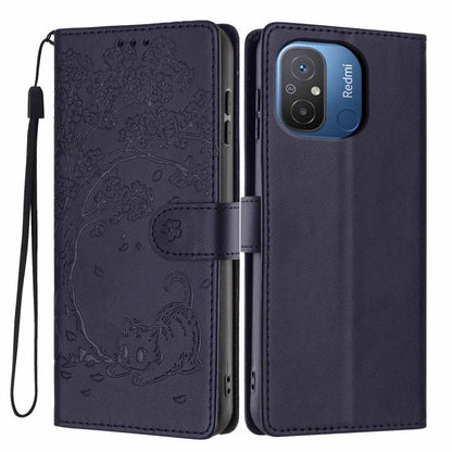 Tree-cat embossed vegan leather flip phone case with wrist strap, deep navy blue.