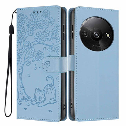 Light blue cat-embossed flip vegan leather phone case with wrist strap, front and back