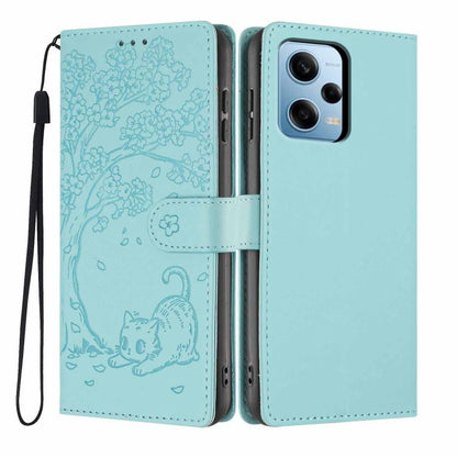 Tree cat embossed flip phone case in light blue, with wrist strap and camera cutout