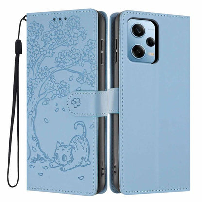 Light blue embossed flip phone case with cat illustration and wrist strap