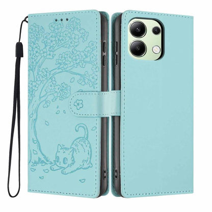 Light blue flip vegan leather phone case with embossed tree cat and wrist strap.