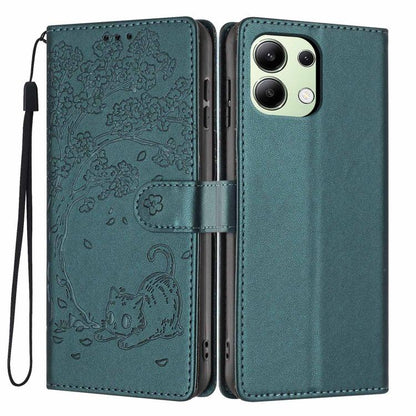 Teal green flip vegan leather phone case with embossed tree cat and wrist strap.