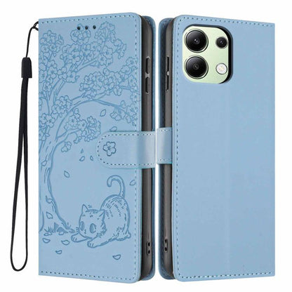 Light blue flip vegan leather phone case with embossed tree cat and wrist strap.