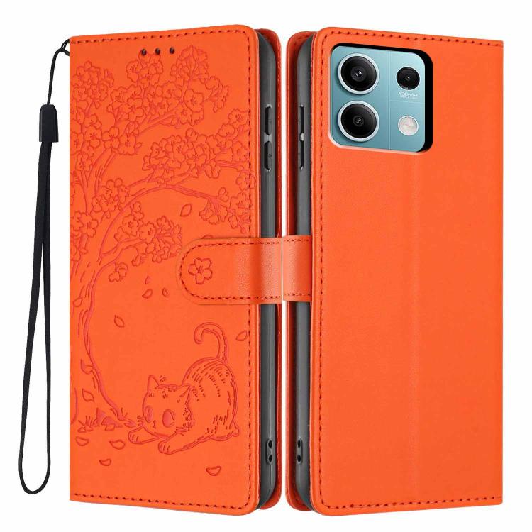 Orange flip vegan leather phone case with embossed tree cat and wrist strap.