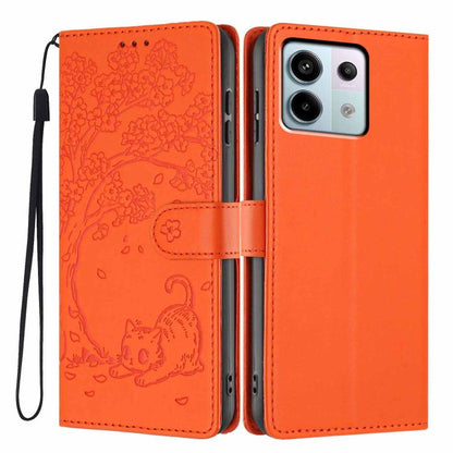 Embossed cat flip phone case in orange vegan leather, with wrist strap and slots