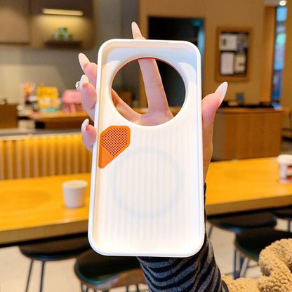 White MagSafe phone case with orange camera-ring trim and vented speaker-style patch