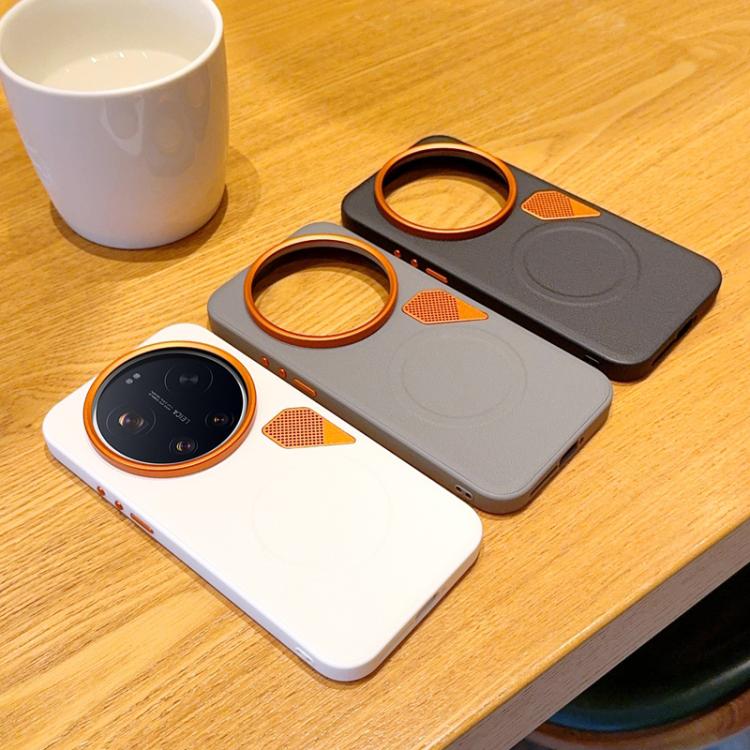 Set of MagSafe phone cases on a tabletop: white and gray with orange camera rings