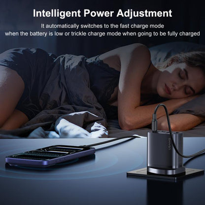 Black GaN fast charger on a base with cable plugged in