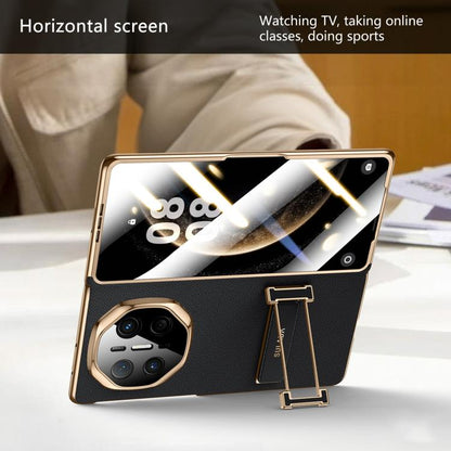 Black genuine leather foldable phone case in landscape mode with wristband stand
