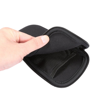 Black zip pouch opened to show mesh organizer pocket inside.